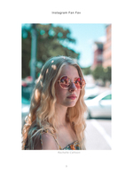 woman in round sunglasses on city street portrait photography