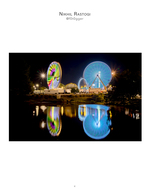 ferris wheels reflected in water at night event photography