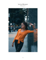 woman leaning against a glass wall portrait photography