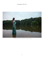 woman in green gown standing in a still lake portrait photography