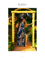 woman in tropical print gown under garden arbor fashion photography
