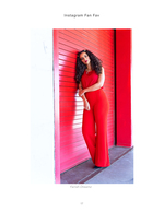 woman in red outfit against red roll-up door fashion photography
