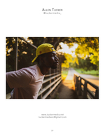 man in yellow cap leaning against a bridge railing portrait photography