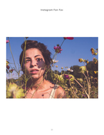 woman surrounded by wildflowers in golden light portrait photography