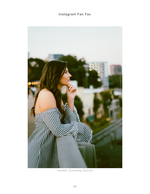 woman in striped dress on a city balcony at dusk fashion photography