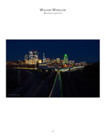 downtown skyline beside curving railroad tracks at night cityscape photography