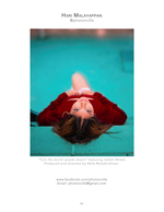woman in red gown floating in a teal pool fashion photography
