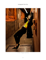 woman leaning against a doorway in an alley fashion photography