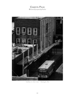 city bus passing brick buildings and a covered walkway cityscape photography