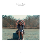 woman seated on vintage suitcase with halo light portrait photography