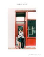 couple embracing at red doorway engagement photography