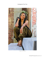 woman in olive jumpsuit on brick ledge portrait photography