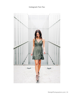 woman in green dress between glass walls portrait photography