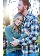 couple embracing in a sunlit park engagement photography
