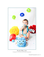 baby smashing a monster-themed birthday cake portrait photography