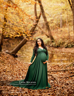 pregnant woman in emerald gown beside a creek maternity photography