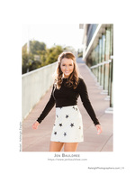 woman in star-print skirt on a rooftop walkway senior portrait photography