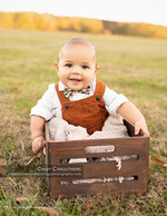 baby in bow tie sitting in a wooden crate portrait photography
