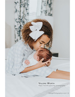 big sister kissing her newborn sibling newborn photography