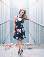 woman in floral dress beside a reflecting pool senior portrait photography