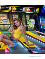 woman posing on an arcade skee-ball lane fashion photography