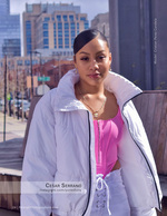 woman in white puffer jacket on a city rooftop fashion photography
