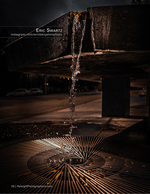water cascading off a parking deck grate at night urban photography