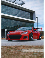 red sports coupe parked outside a modern office building automotive photography
