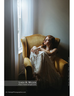 woman seated in a gold armchair by a window portrait photography