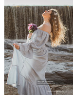 woman holding flowers in front of a waterfall portrait photography