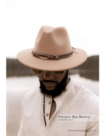 man in a wide-brim hat and sunglasses by a lake portrait photography