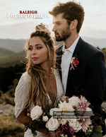 couple embracing with a bouquet against a mountain vista back cover wedding photography