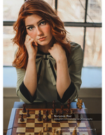 redheaded woman leaning over a chess board portrait photography
