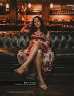 woman in red floral dress on leather couch fashion photography