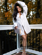 woman in oversized white shirt on a balcony portrait photography