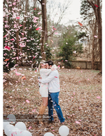 couple embracing in pink confetti with balloons event photography
