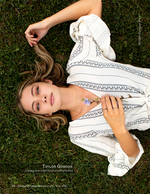 woman lying in the grass holding a wildflower portrait photography