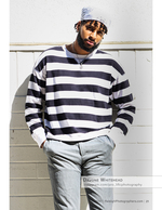 man in striped shirt and bandana against a block wall portrait photography