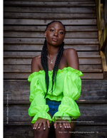 woman in a neon green top against weathered wood fashion photography