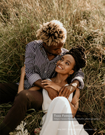 couple embracing in a tall grass field portrait photography