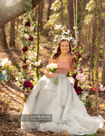 girl on a flower-decorated swing holding tulips portrait photography