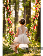 girl in lace dress seen from behind on a floral swing family photography