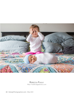 newborn on a quilt with sibling peeking through fingers family photography