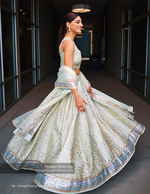 woman twirling in a sequined lehenga in a hallway fashion photography