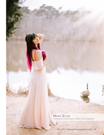 woman with pink hair standing by a lake with geese portrait photography