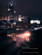 freight train arriving beneath the Raleigh skyline at night cityscape photography