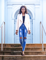 woman in ripped jeans on white columned steps portrait photography