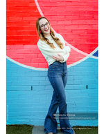 woman laughing against a colorful mural senior portrait photography