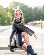 woman in fur coat and sunglasses on a bridge fashion photography