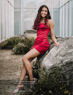 girl in red dress leaning on a boulder senior portrait photography